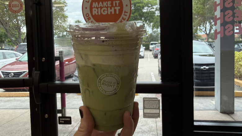 Franki Matcha in front of Dunkin' door