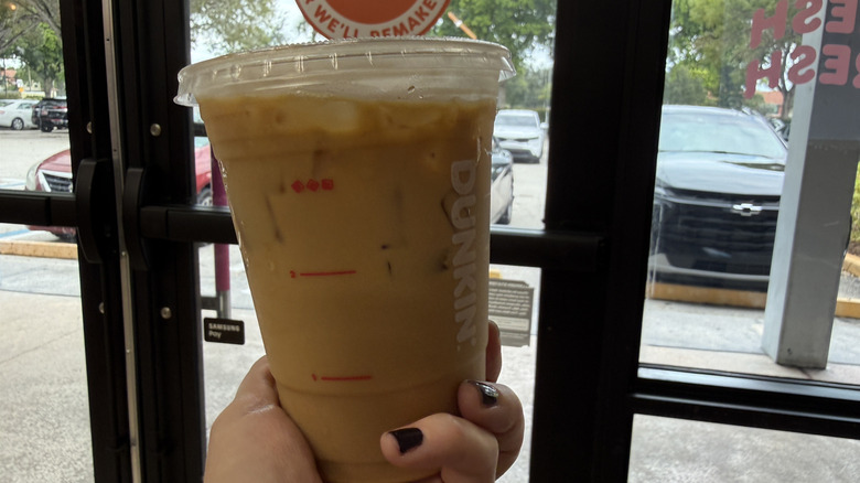 Nutty Nightmare Iced Coffee in front of Dunkin' door