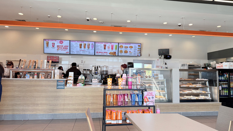Dunkin' menu behind counter in store
