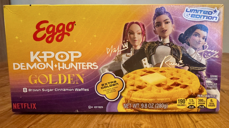 A yellow and purple Eggo waffle box with KPop Demon Hunters characters
