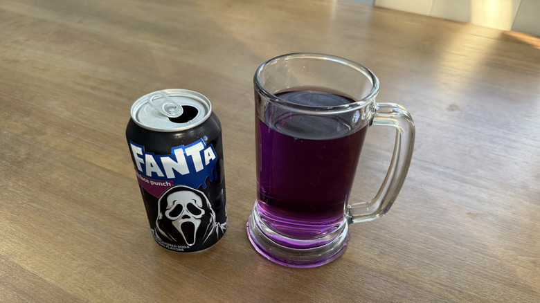 Fanta Ghost Face Punch poured into a glass on a wooden table