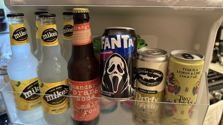 a fridge shelf full of drinks