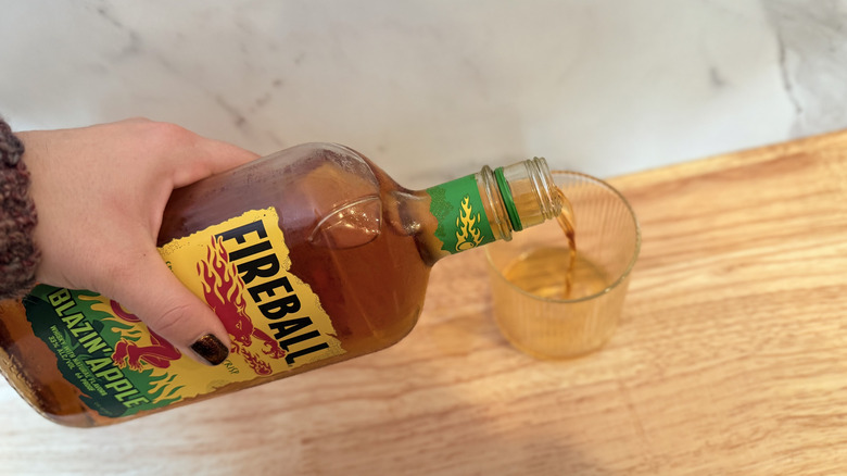 Pouring Blazin' Apple into a rocks glass