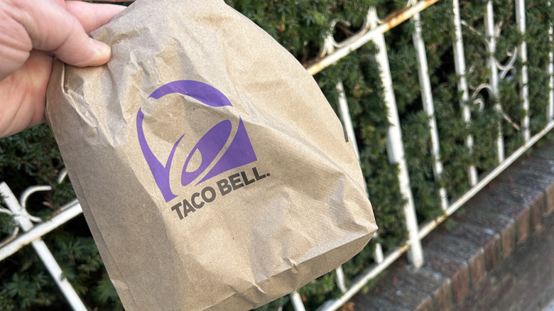 A packaged Volcano Quesarito on a coaster, on a table