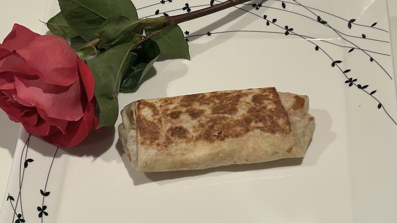 A whole Volcano Quesarito on a white tabletop.