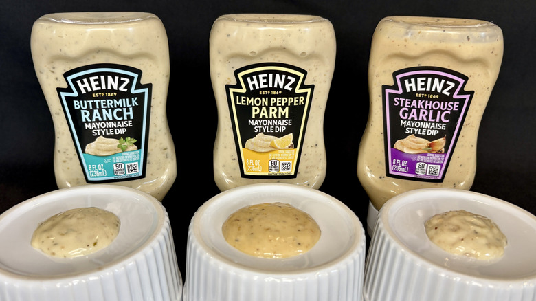 Three sauces on white dishes with Heinz bottles in background