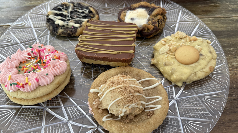 Six Crumbl cookies on a plate