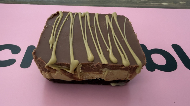 Dubai-Style Chocolate Brownie on top of a pink Crumbl box