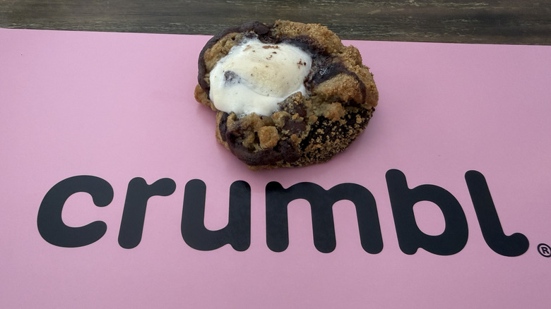 Crumbl S'mores Brownie Cookie on top of pink box