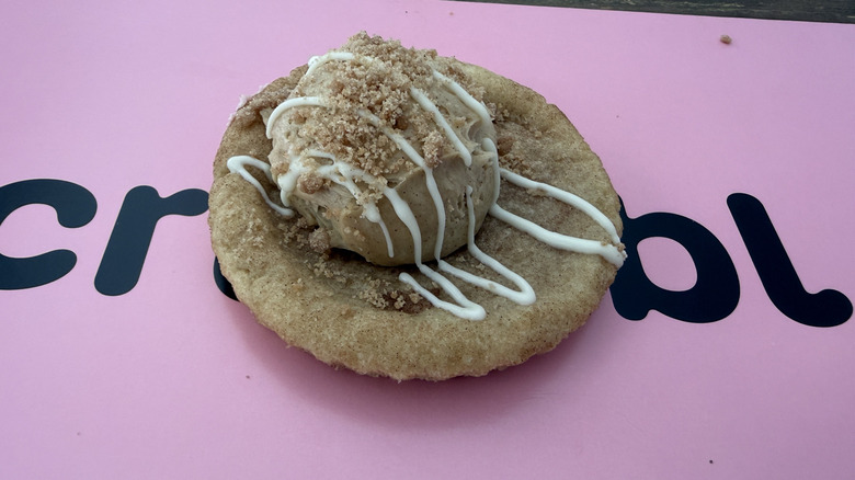 Crumbl Snickerdoodle Skillet Cookie on top of a pink Crumbl box