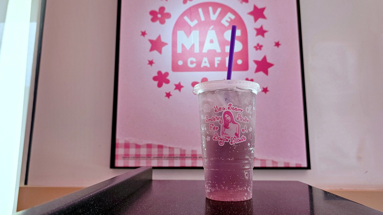 Pretty Pink Baja Blast in front of poster