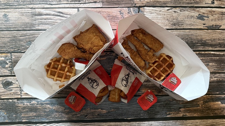 open boxes of chicken and waffles and poppers
