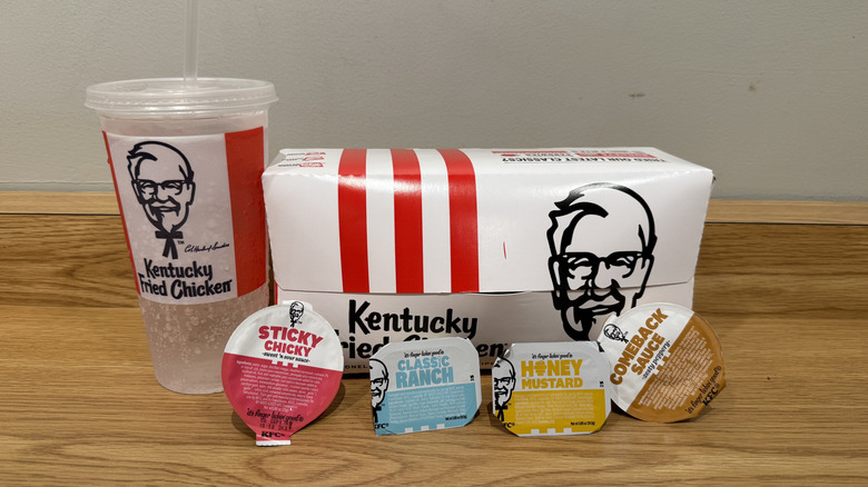 a KFC order with drink, box of Fried Pickles and dipping sauces