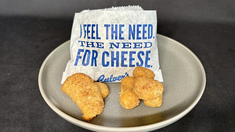 Culver's cheese curds with small paper bag on plate