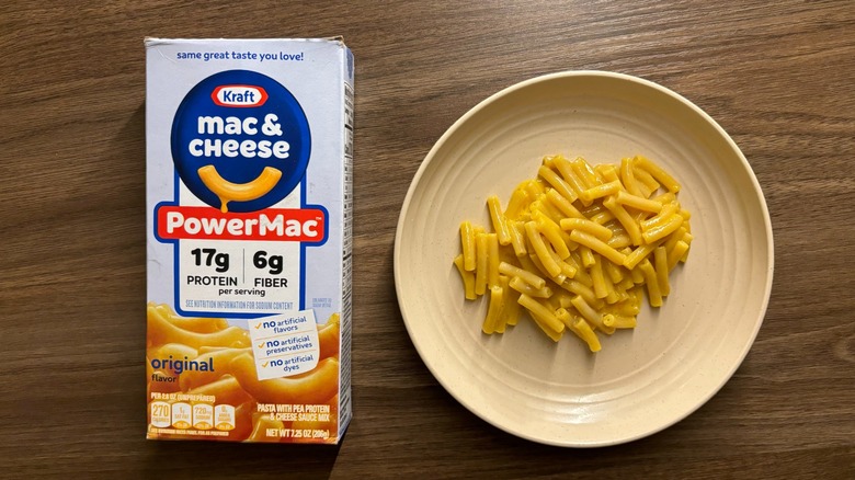 Kraft PowerMac box next to macaroni and cheese on a small round plate