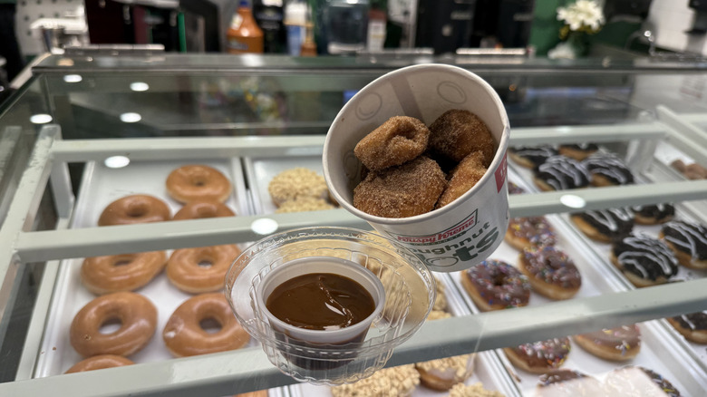 Krispy Kreme Churro Dot Doughnuts with dulce de leche sauce on a counter