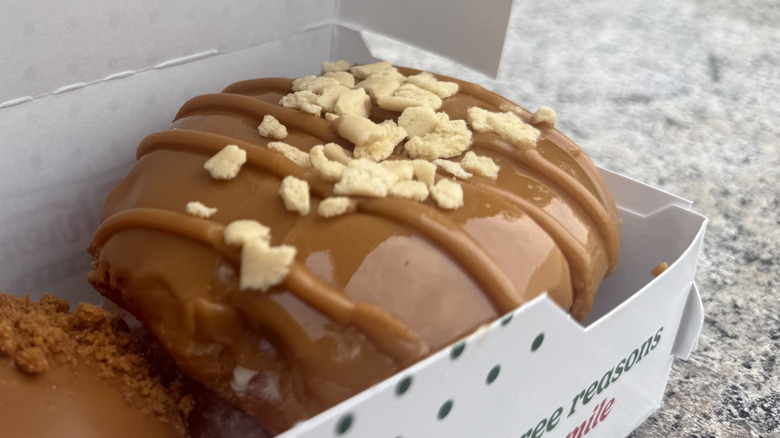 Close up of maple cheesecake doughnut in Krispy Kreme box
