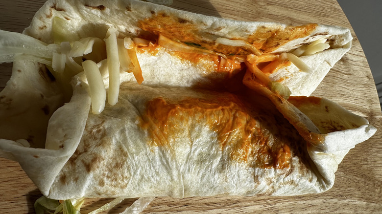 Two McDonald's Buffalo Ranch snack wraps on wooden table