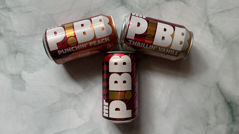Three cans of Mr. Pibb in the shape of a T