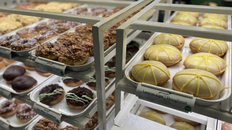 Racks of Krispy Kreme Girl Scout Cookie Inspired Doughnuts on display