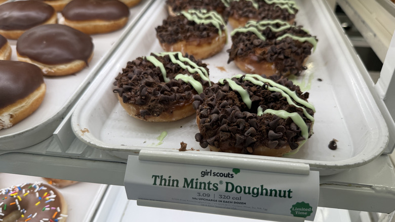 Krispy Kreme Thin Mints Doughnuts on a tray in a display case