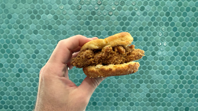 Honey Chicken Biscuit held in the air
