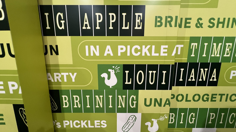 a lord of words on a wall in various shades of green