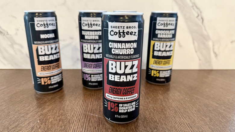 Collection of Sheetz Buzz Beanz coffee cans with cinnamon churro in the forefront