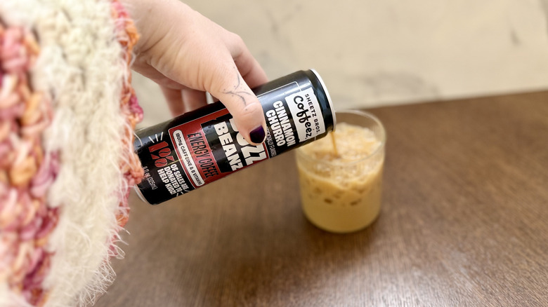 Pouring cinnamon churro Sheetz Buzz Beanz coffee into a glass with ice