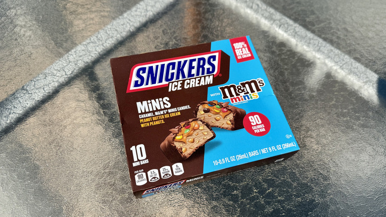 A box of Snickers Ice Cream Minis With M&M's Minis on the table