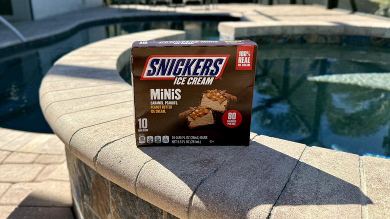 A box of Original Snickers Ice Cream Minis by the pool
