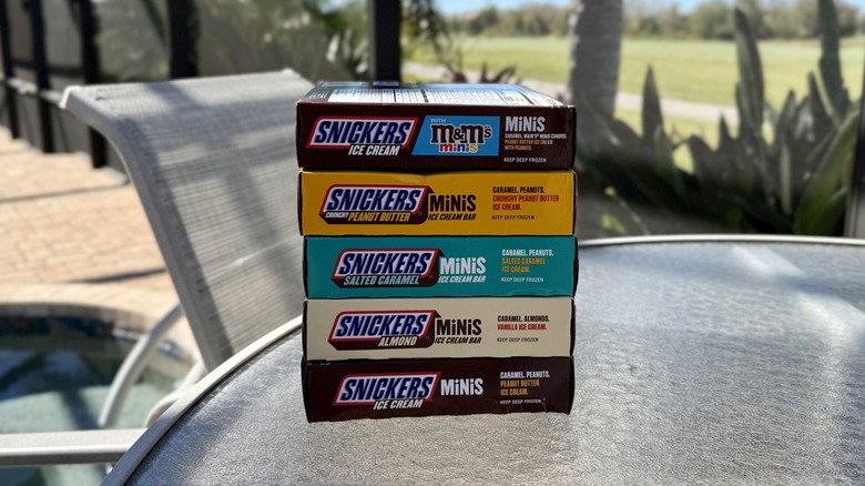 Boxes of all Snickers Ice Cream Minis flavors stacked on an outdoor table