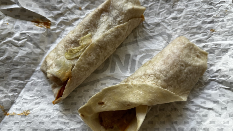 Sonic Crispy Tender Wraps open with sauce and chicken leaking out