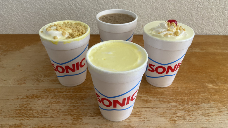 All four Sonic banana drinks with no lids in a diamond arrangement