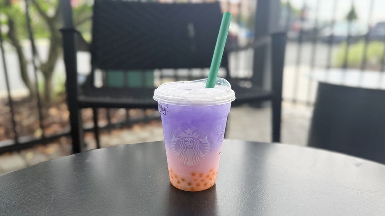 Butterfly Drink from Starbucks in a plastic to-go cup on a black table