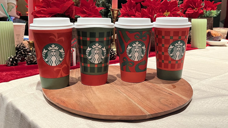 A lineup of Starbuck holiday to-go cups