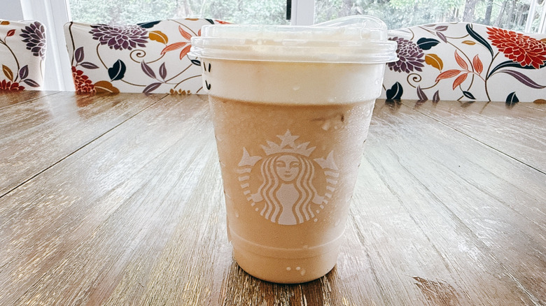 Starbucks iced mango cream chai on a wooden table