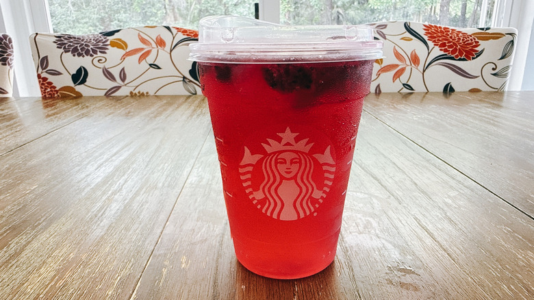 Starbucks iced mango dragonfruit lemonade on a wooden table