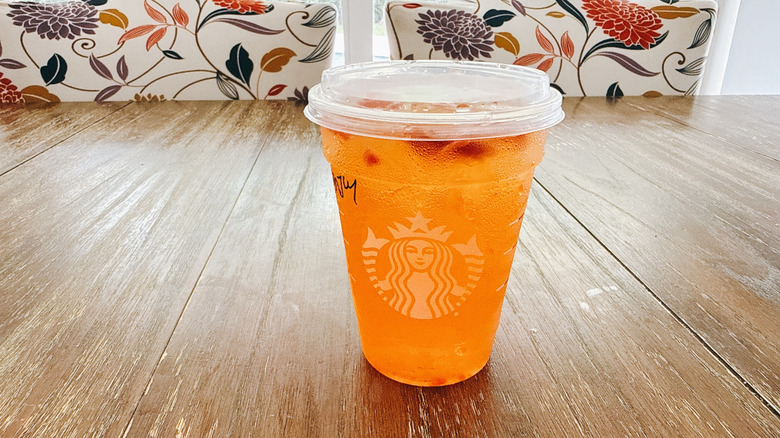 Starbucks mango strawberry lemonade refresher on a wooden table