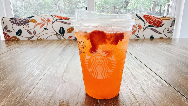 Starbucks mango strawberry refresher on a wooden table