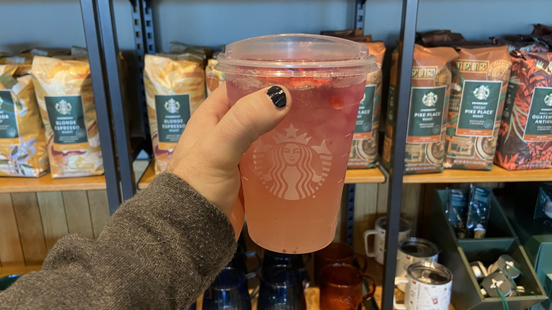 hand holding Cannon Ball Drink by Starbucks merch