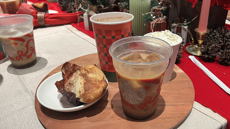 An assortment of Starbucks holiday treats sitting on a wooden board