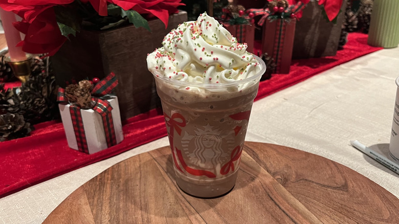 A Starbucks holiday cup filled with frozen peppermint hot chocolate