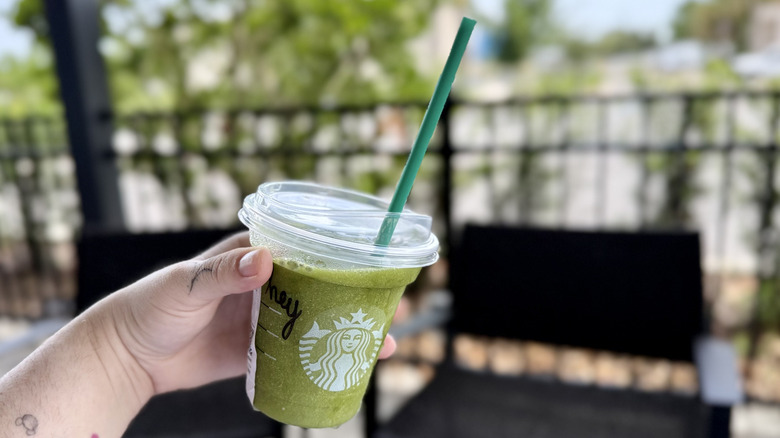 Holding blending Matcha Lemonade