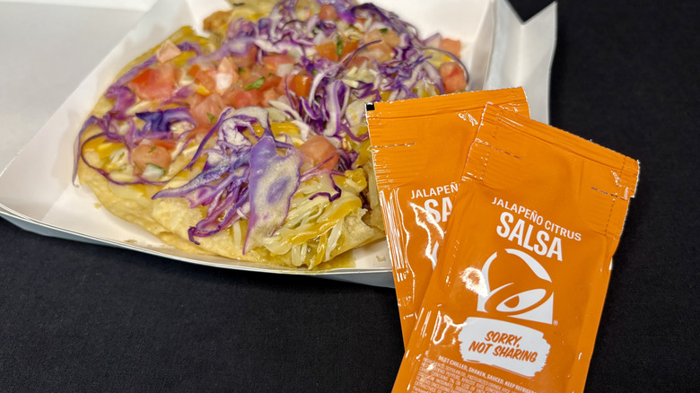 Taco Bell sauce packets next to taco pizza
