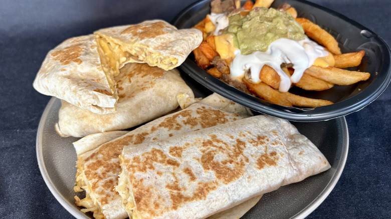 rolled quesadilla, crunchwraps, and nachos on plate