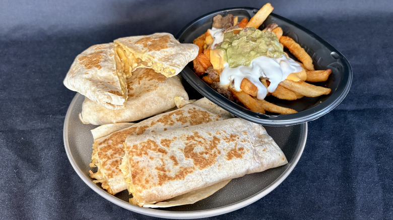 rolled quesadilla, crunchwraps, and nachos on plate