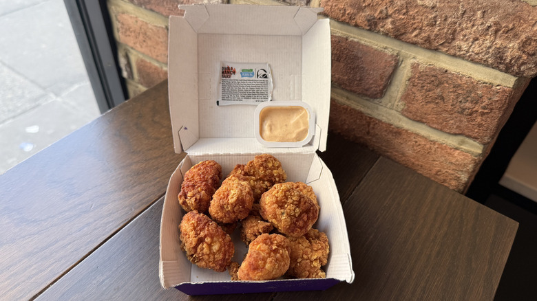 A box of Crispy Chicken Nuggets and a cup of Hidden Valley Diablo Ranch Sauce from Taco Bell