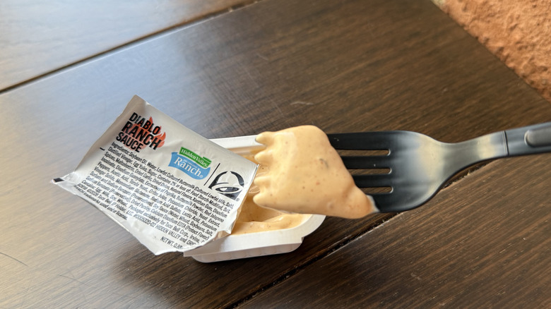 A forkful of Taco Bell's Hidden Valley Diablo Ranch Sauce