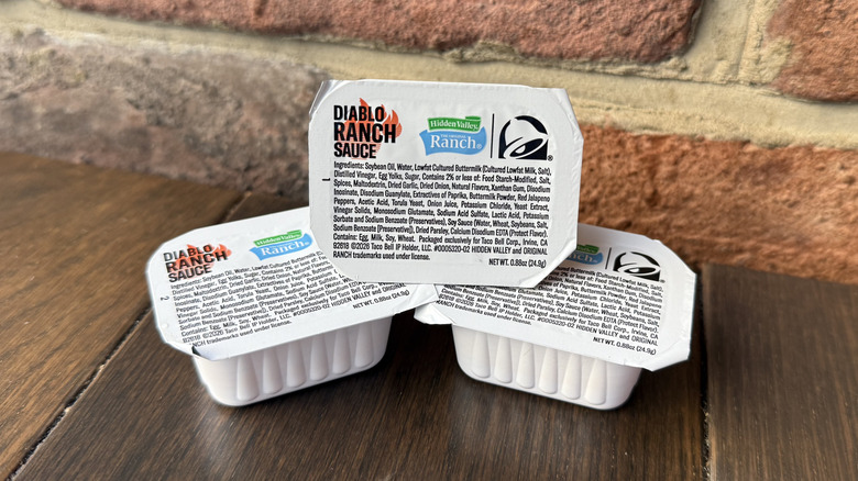 A stack of three Hidden Valley Diablo Ranch Sauces from Taco Bell